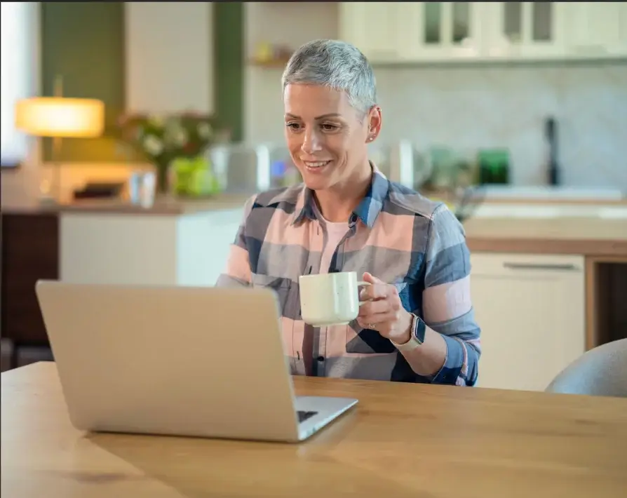 A caregiver using a laptop at home